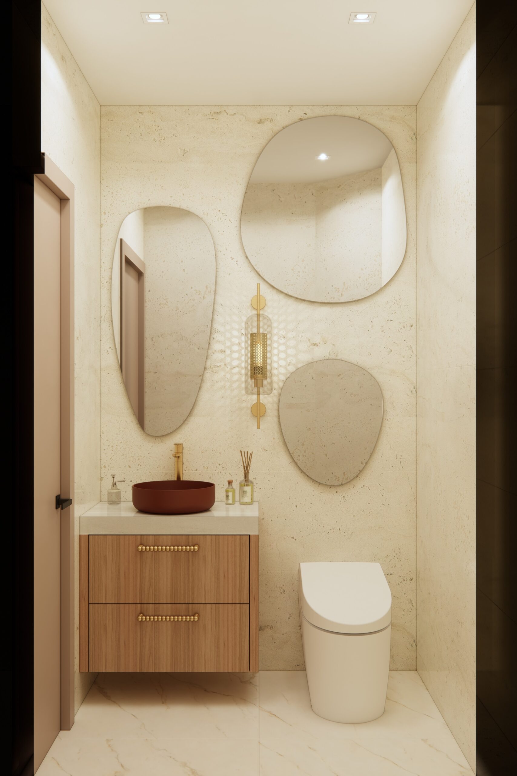 Compact powder room with custom vanity, sculptural mirrors, and warm stone walls