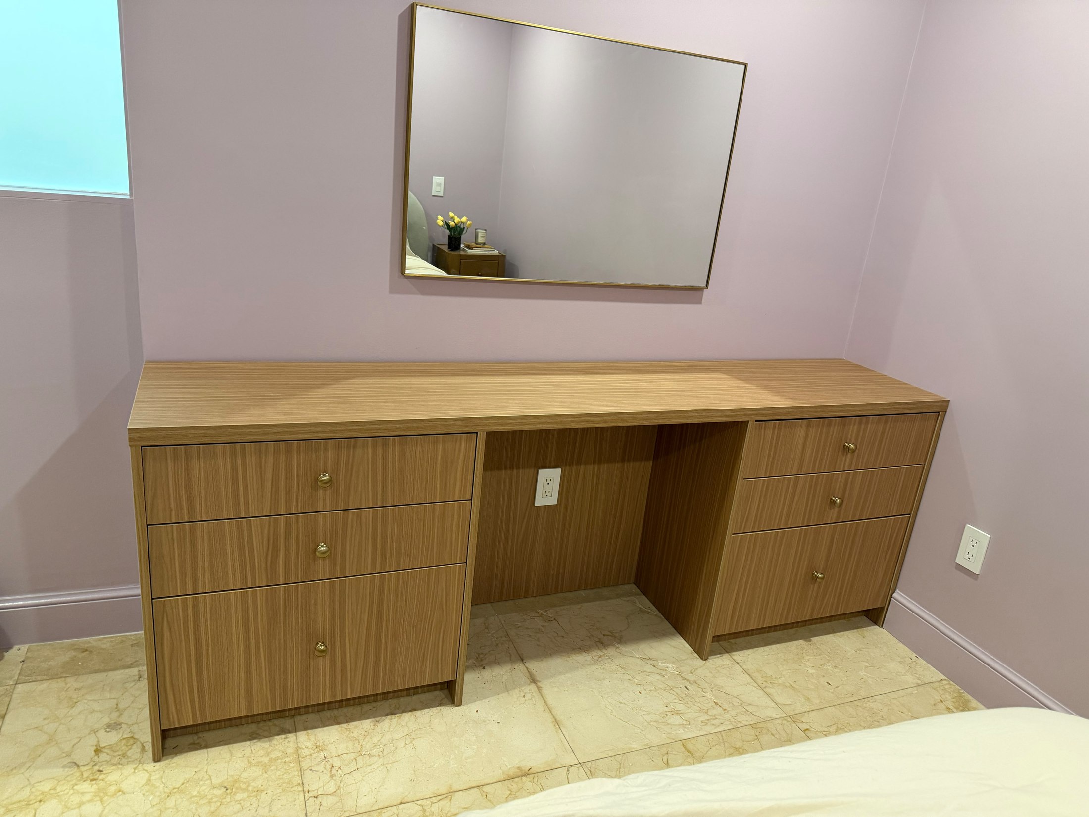 Custom built-in vanity and mirror composed as a compact millwork intervention