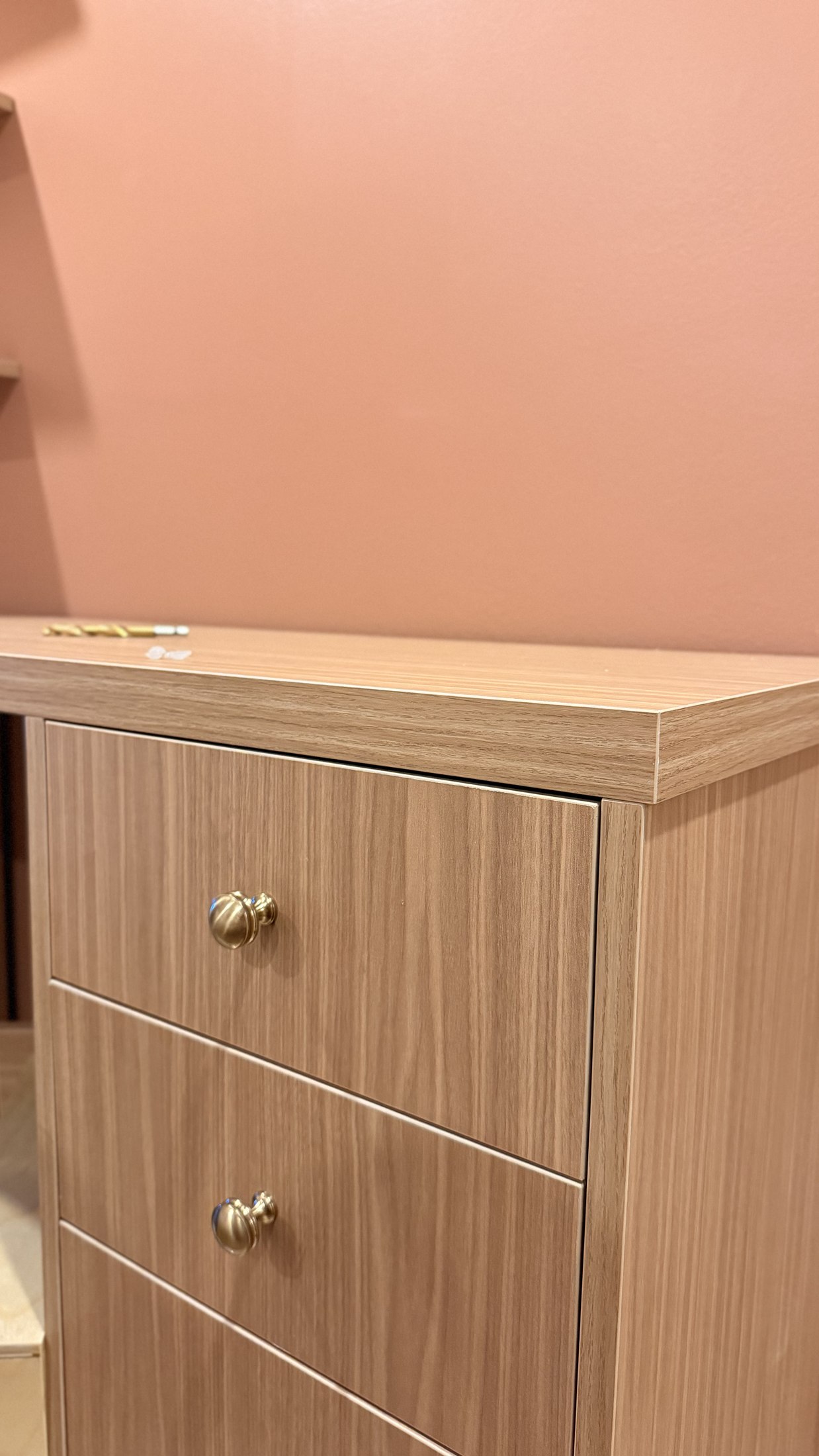 Warm wood grain, edge profile, and hardware detail on custom millwork